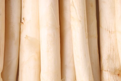 Photo of Raw white asparagus spears as background, closeup