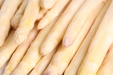 Photo of Raw white asparagus spears as background, closeup