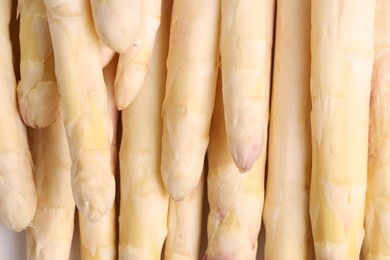 Photo of Raw white asparagus spears as background, closeup