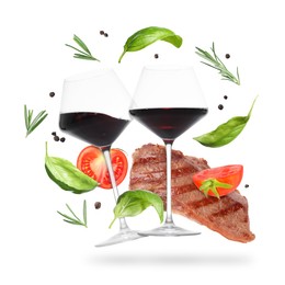 Image of Red wine in glasses, grilled beef steak, tomatoes and spices falling on white background