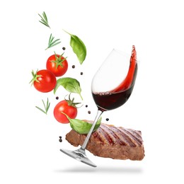 Image of Red wine in glass, grilled beef steak, tomatoes and spices falling on white background