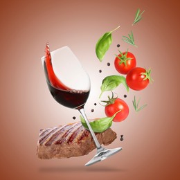 Image of Red wine in glass, grilled beef steak, tomatoes and spices falling on brown gradient background