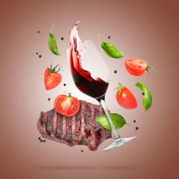 Image of Red wine in glass, grilled beef steak, tomatoes and spices falling on brown gradient background