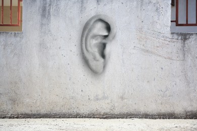 Image of Human ear in old white wall. Eavesdropping, concept that even walls have ears
