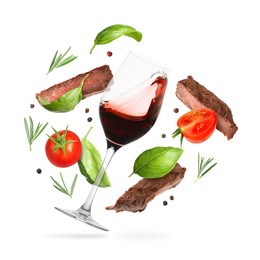 Image of Red wine in glass, grilled beef meat, tomatoes and spices falling on white background