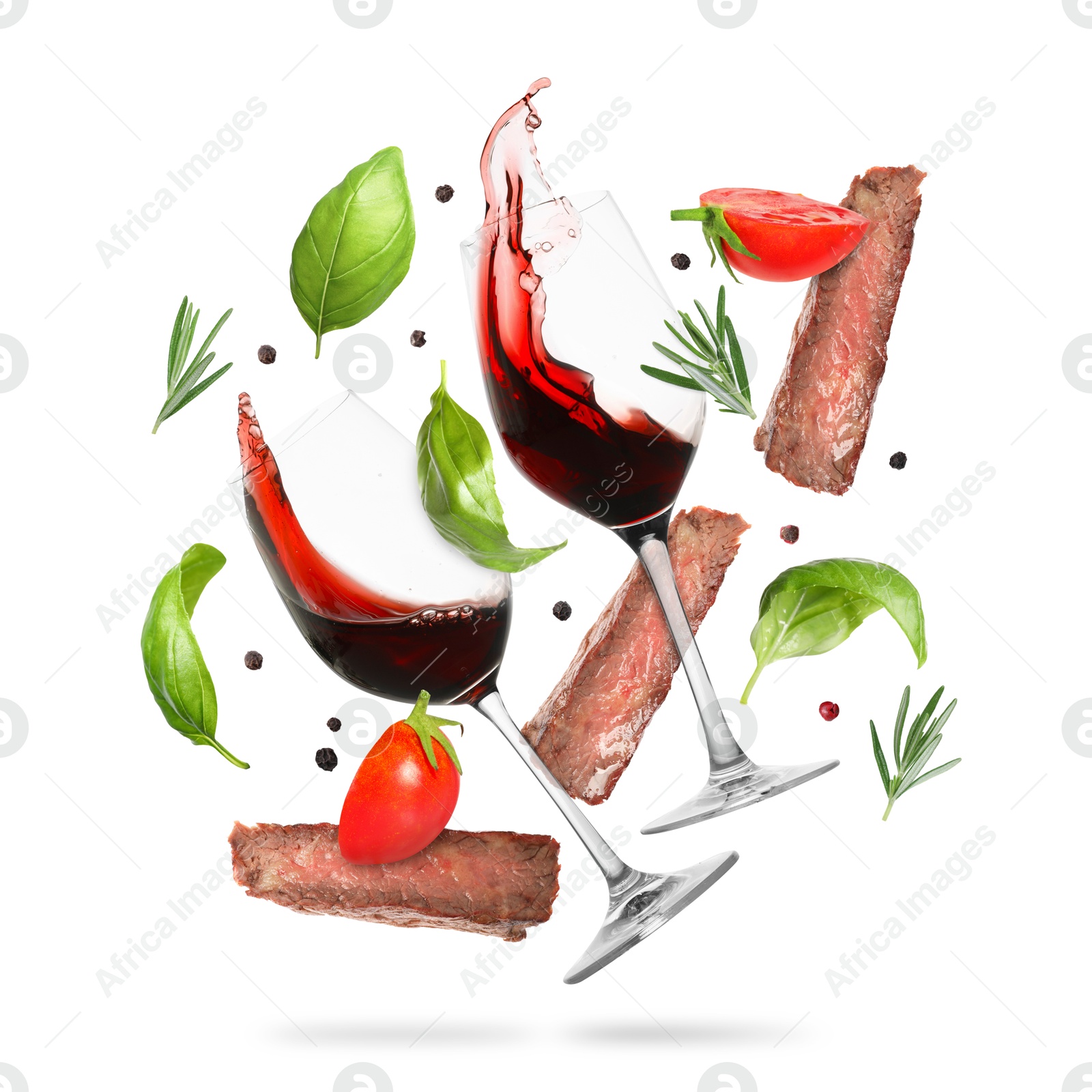 Red wine in glasses, grilled beef meat, tomatoes and spices falling on white background Image of Red wine in glasses, grilled beef meat, tomatoes and spices falling on white background