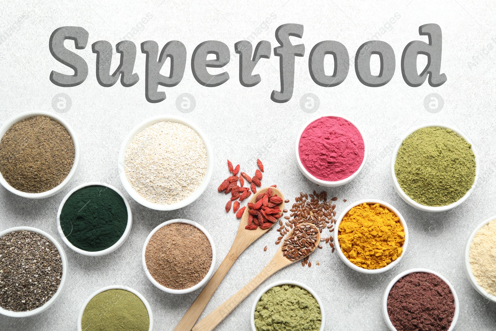 Superfood. Different powders and food products on light table, flat lay Image of Superfood. Different powders and food products on light table, flat lay