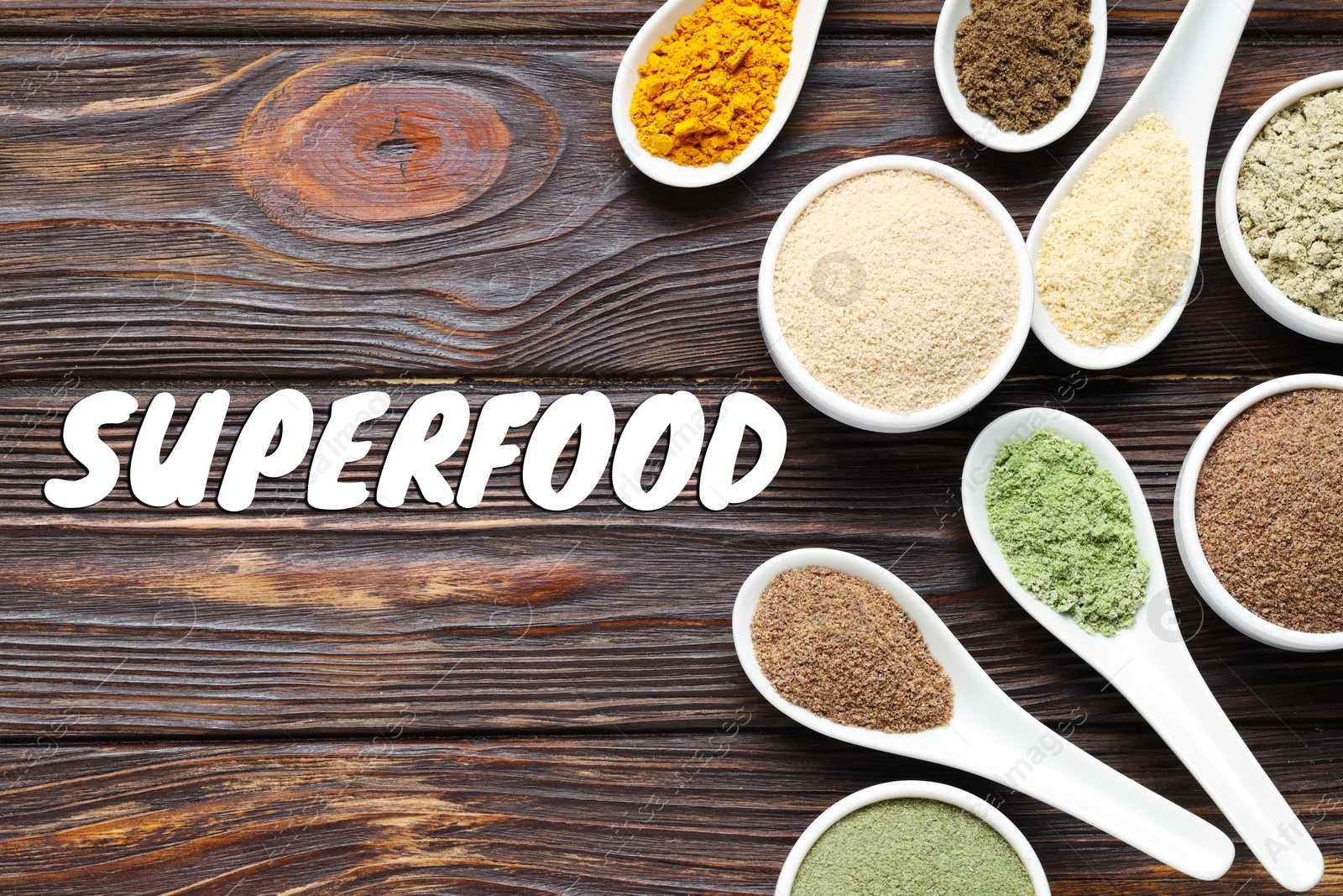 Superfood. Different powders in bowls and spoons on wooden table, flat lay Image of Superfood. Different powders in bowls and spoons on wooden table, flat lay