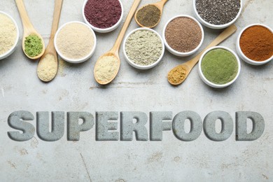 Image of Superfood. Different powders and chia seeds on grey table, flat lay