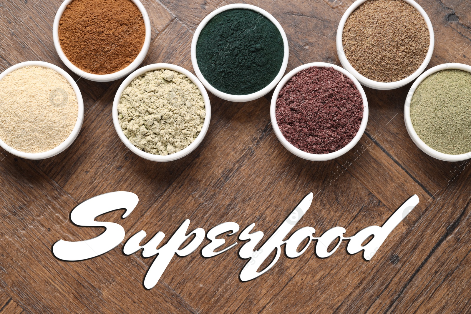 Superfood. Different powders in bowls on wooden table, flat lay Image of Superfood. Different powders in bowls on wooden table, flat lay