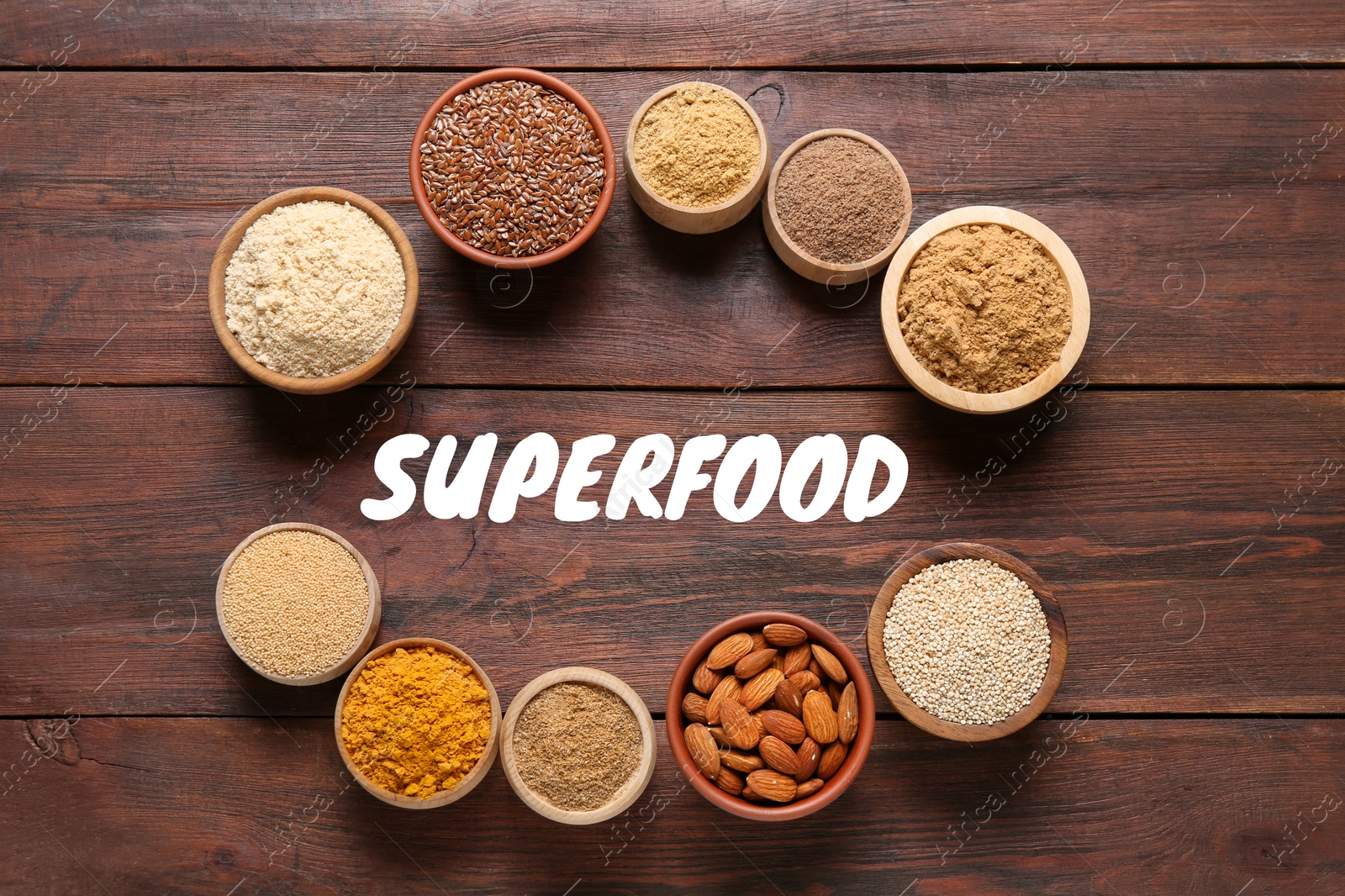 Image of Different superfoods in bowls on wooden table, flat lay