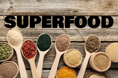 Image of Superfood. Different powders and food products on wooden table, flat lay