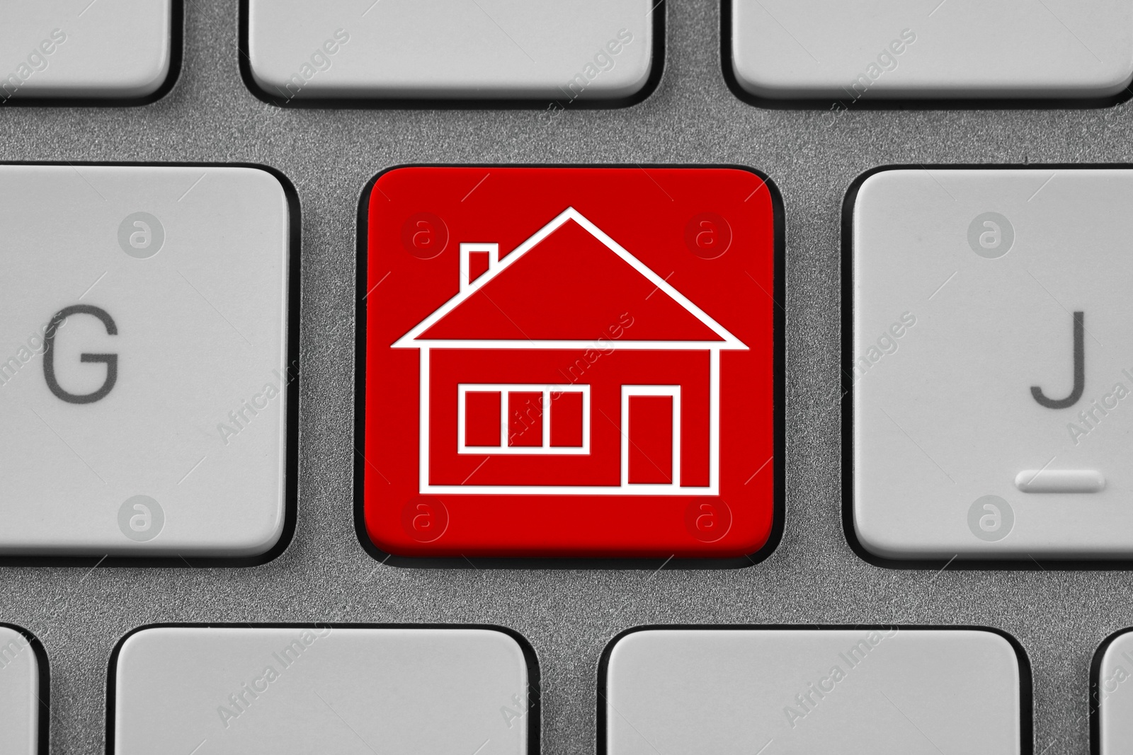Image of Online accommodation search. Button with house icon on computer keyboard, closeup