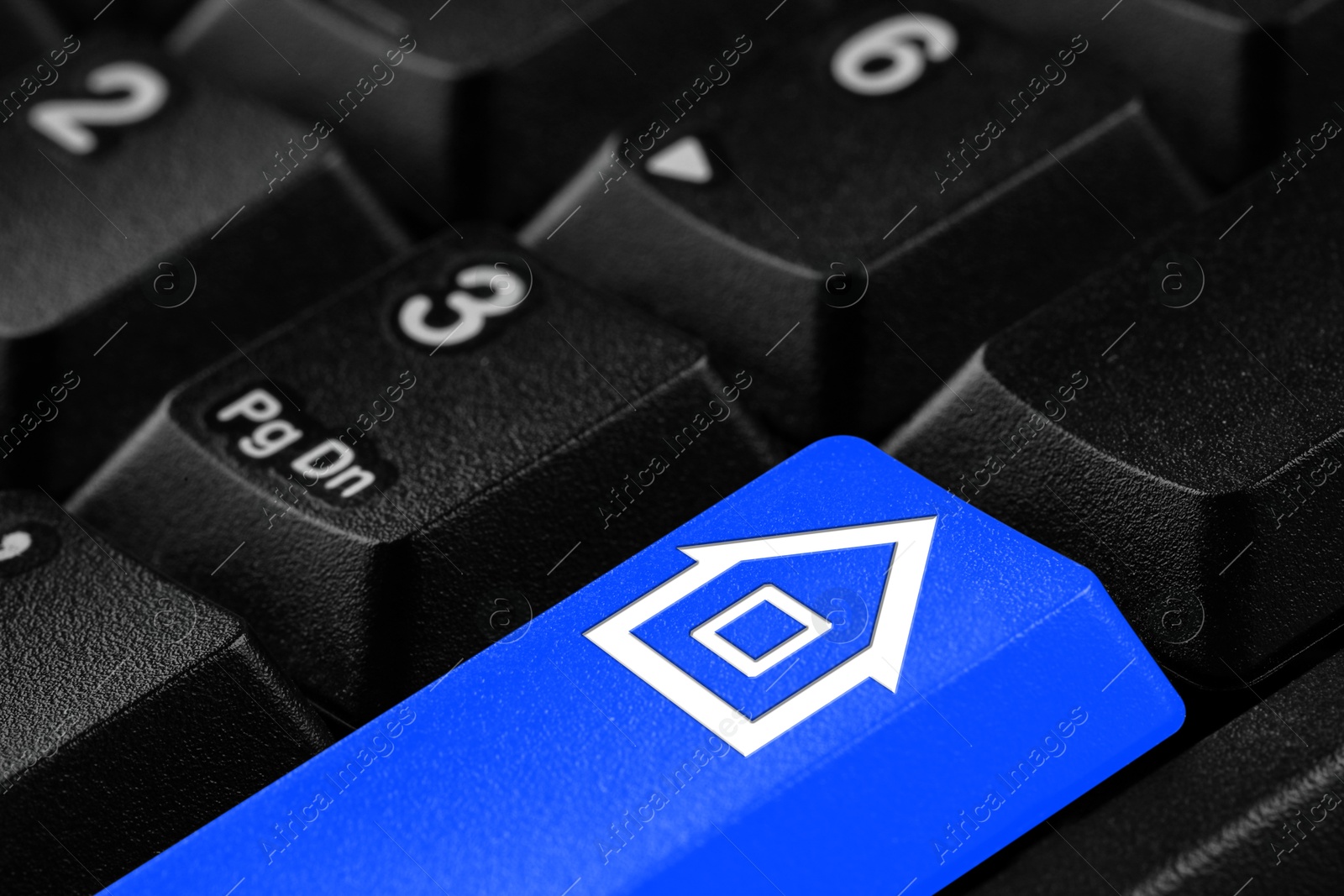 Image of Online accommodation search. Button with house icon on computer keyboard, closeup