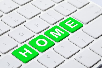 Image of Online accommodation search. Word Home on computer keyboard, closeup