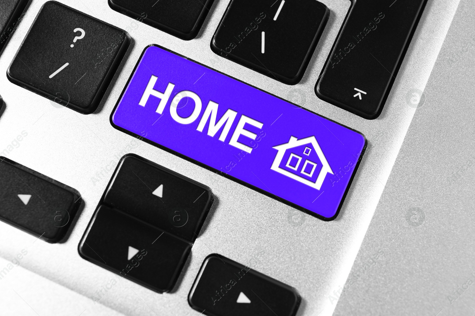 Image of Online accommodation search. Button with house icon and word Home on computer keyboard, closeup