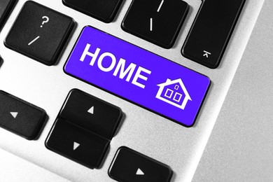 Image of Online accommodation search. Button with house icon and word Home on computer keyboard, closeup