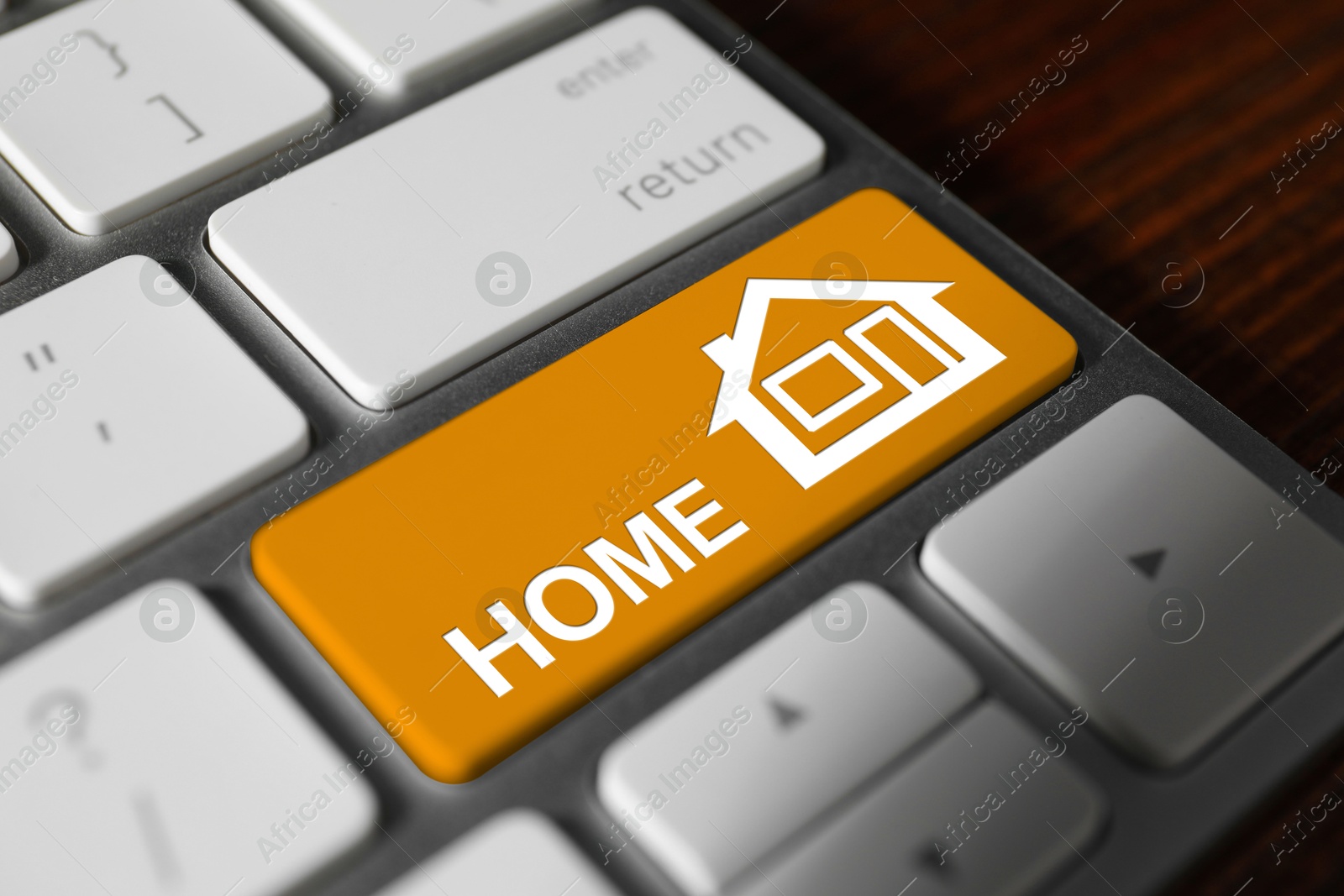 Image of Online accommodation search. Button with house icon and word Home on computer keyboard, closeup