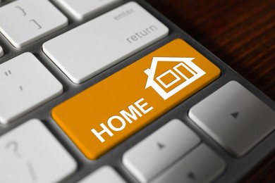 Image of Online accommodation search. Button with house icon and word Home on computer keyboard, closeup