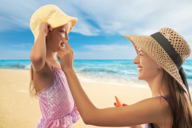 Image of Mother applying sunscreen onto her daughter's face at beach. Sun protection while outdoor recreation in summer
