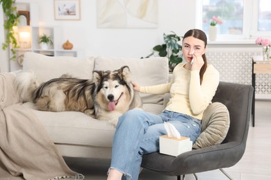 Photo of Woman suffering from allergy with her dog at home