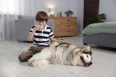 Photo of Boy suffering from allergy with her dog at home