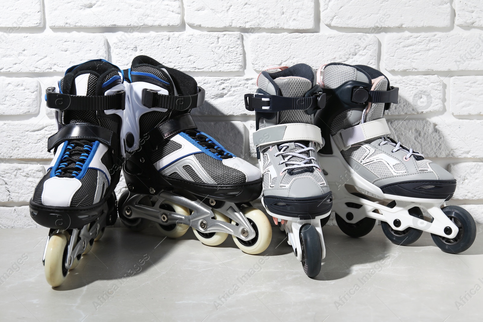 Roller skates on grey marble table near white brick wall Photo of Roller skates on grey marble table near white brick wall