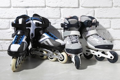 Photo of Roller skates on grey marble table near white brick wall