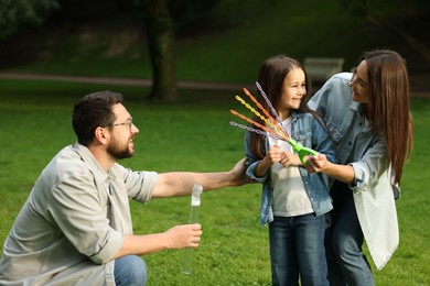 Photo of Happy family spending time together in park