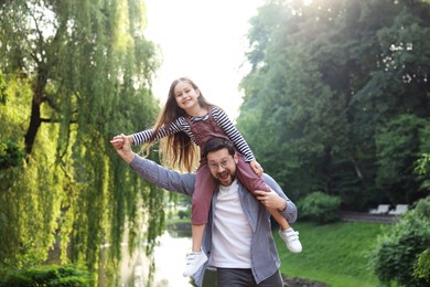 Photo of Family getaway. Happy father and daughter having fun in park