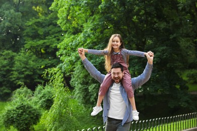 Photo of Family getaway. Happy father and daughter having fun in park. Space for text