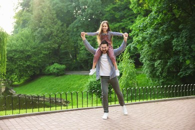 Photo of Family getaway. Happy father and daughter having fun in park
