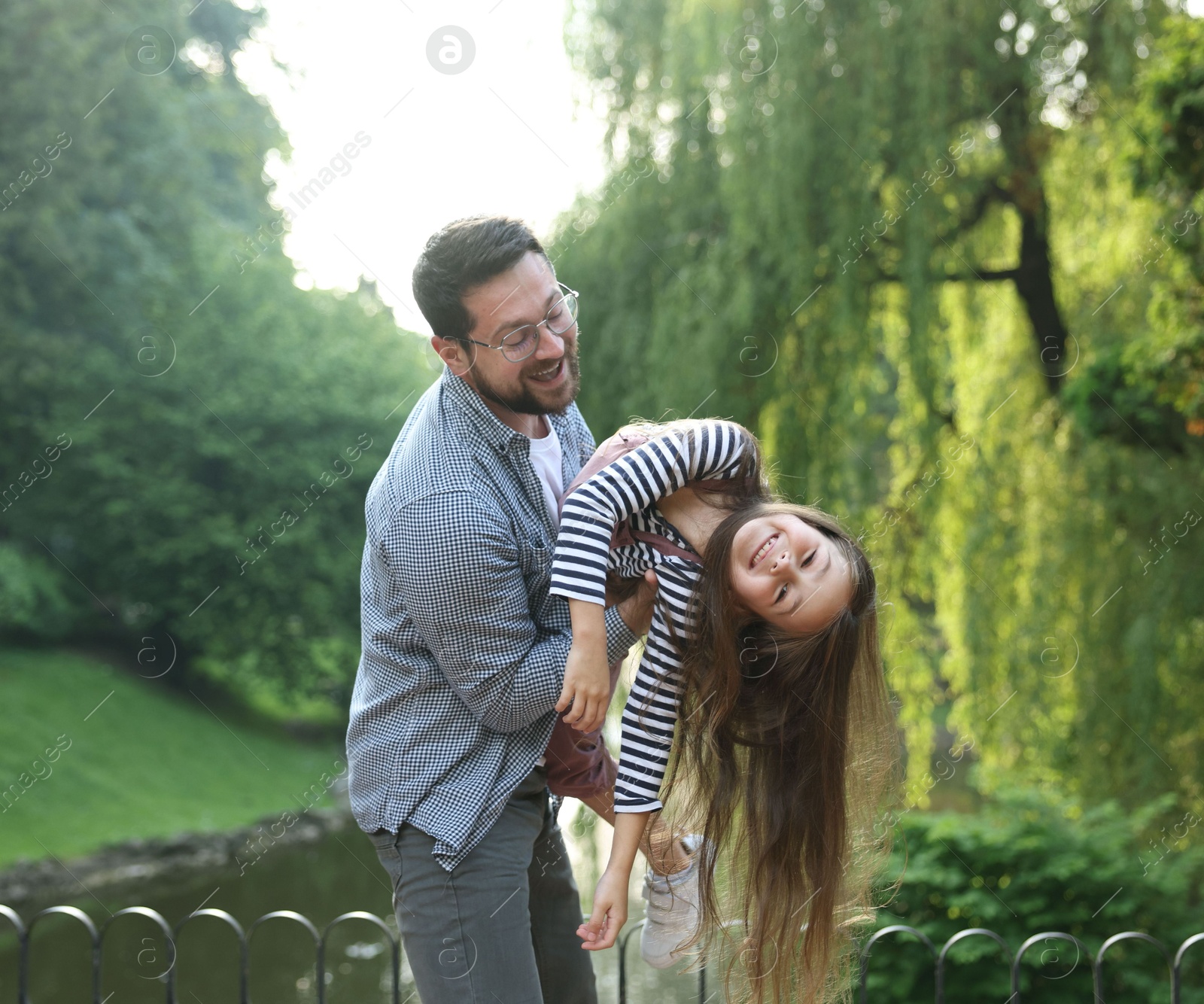 Family getaway. Happy father and daughter having fun in park Photo of Family getaway. Happy father and daughter having fun in park