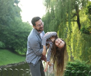 Photo of Family getaway. Happy father and daughter having fun in park