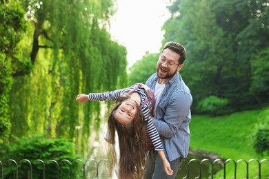 Photo of Family getaway. Happy father and daughter having fun in park