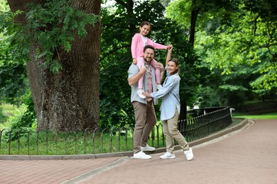 Photo of Happy family spending time together in park
