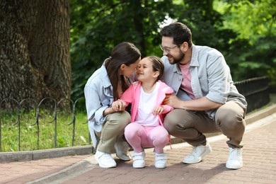Photo of Happy family spending time together in park