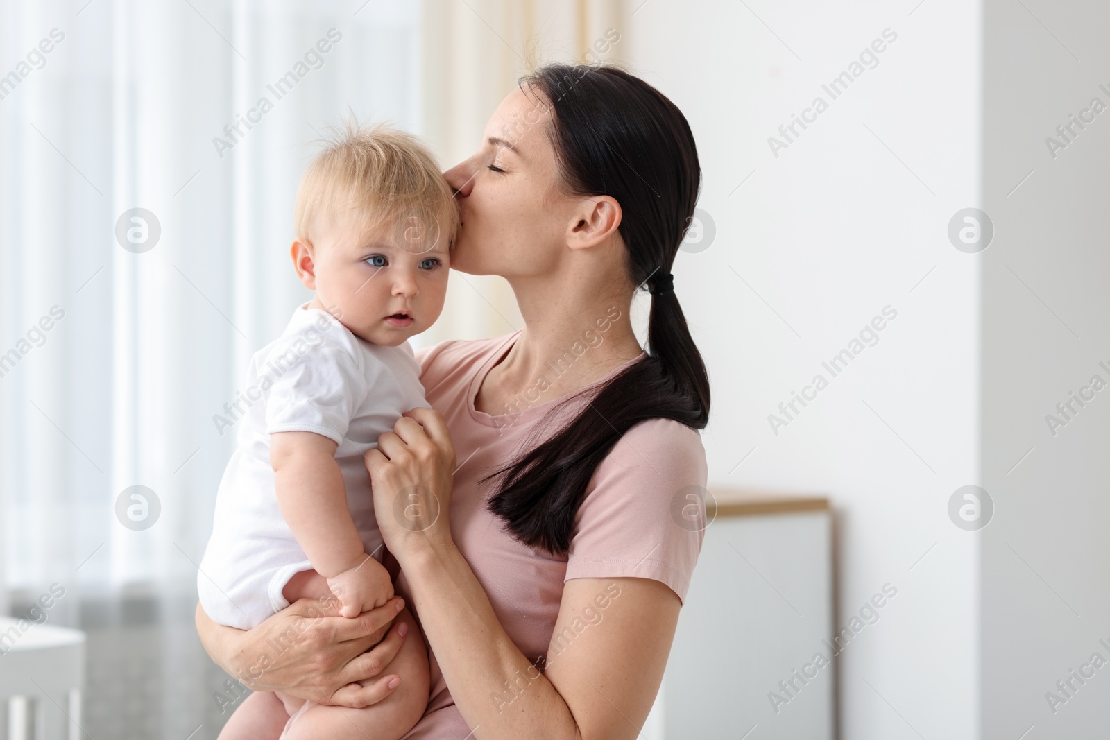 Mother with her little baby at home, space for text Photo of Mother with her little baby at home, space for text