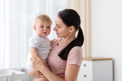 Photo of Mother with her little baby at home
