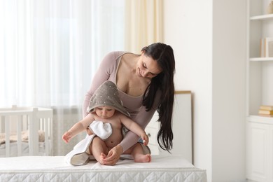 Photo of Mother with her cute baby at home