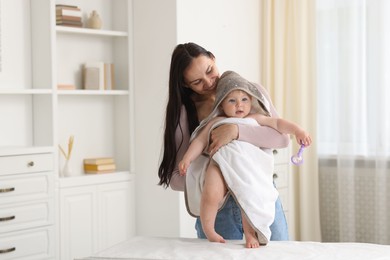 Photo of Mother with her cute baby at home, space for text