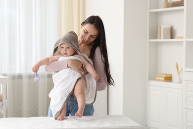 Photo of Mother with her cute baby at home, space for text