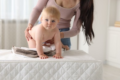 Photo of Mother with her cute baby at home, closeup