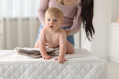 Photo of Mother with her cute baby at home, closeup