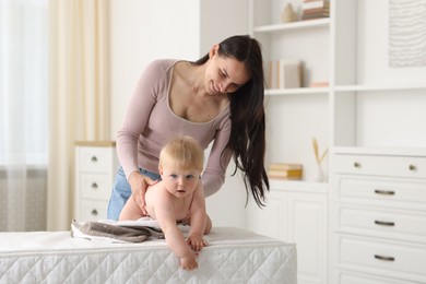 Photo of Mother with her cute baby at home