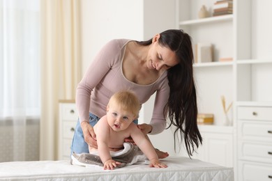 Photo of Mother with her cute baby at home
