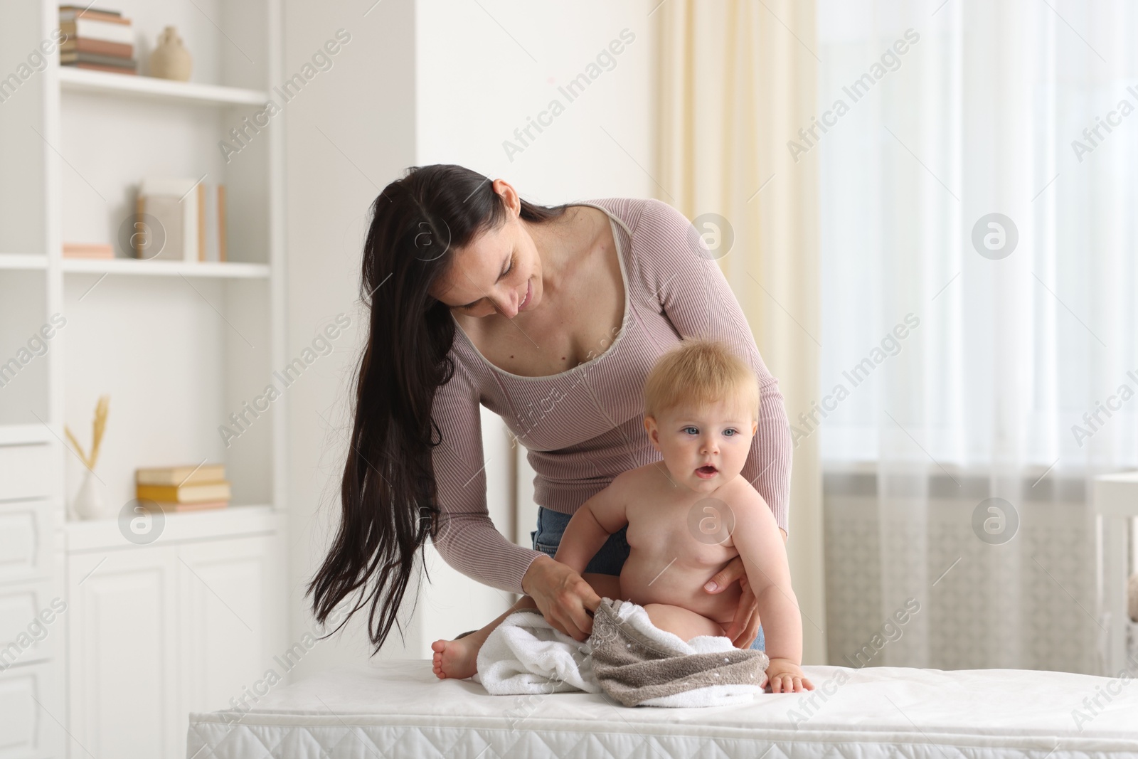 Photo of Mother with her cute baby at home