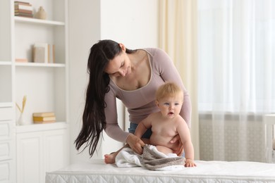 Photo of Mother with her cute baby at home