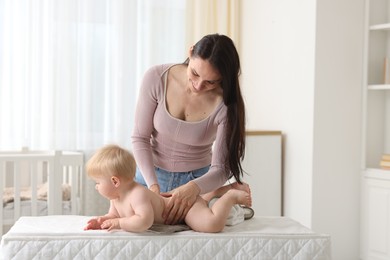 Photo of Mother with her cute baby at home