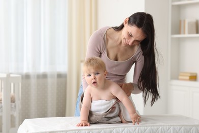 Photo of Mother with her cute baby at home
